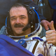 Canadian astronaut Chris Hadfield gestures after the Russian Soyuz space capsule landed some 150 kilometers (94 miles) southeast of the town of Dzhezkazgan in central Kazakhstan, Tuesday, May 14, 2013. The Soyuz space capsule carrying a three-man crew returning from a five-month mission to the International Space Station landed safely Tuesday on the steppes of kazakhstan. (AP Photo/ Sergei Remezov, Pool)